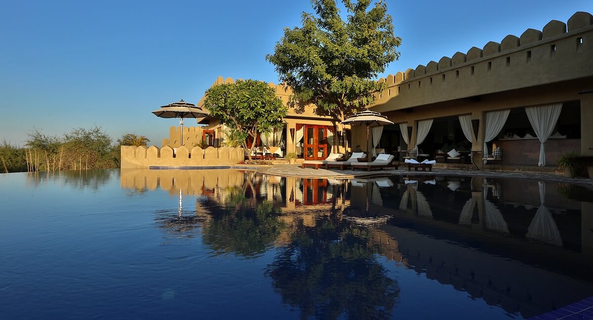 Luxury boutique hotel Mihirgarh, a desert fort in Jodhpur, Rajasthan, at golden hour