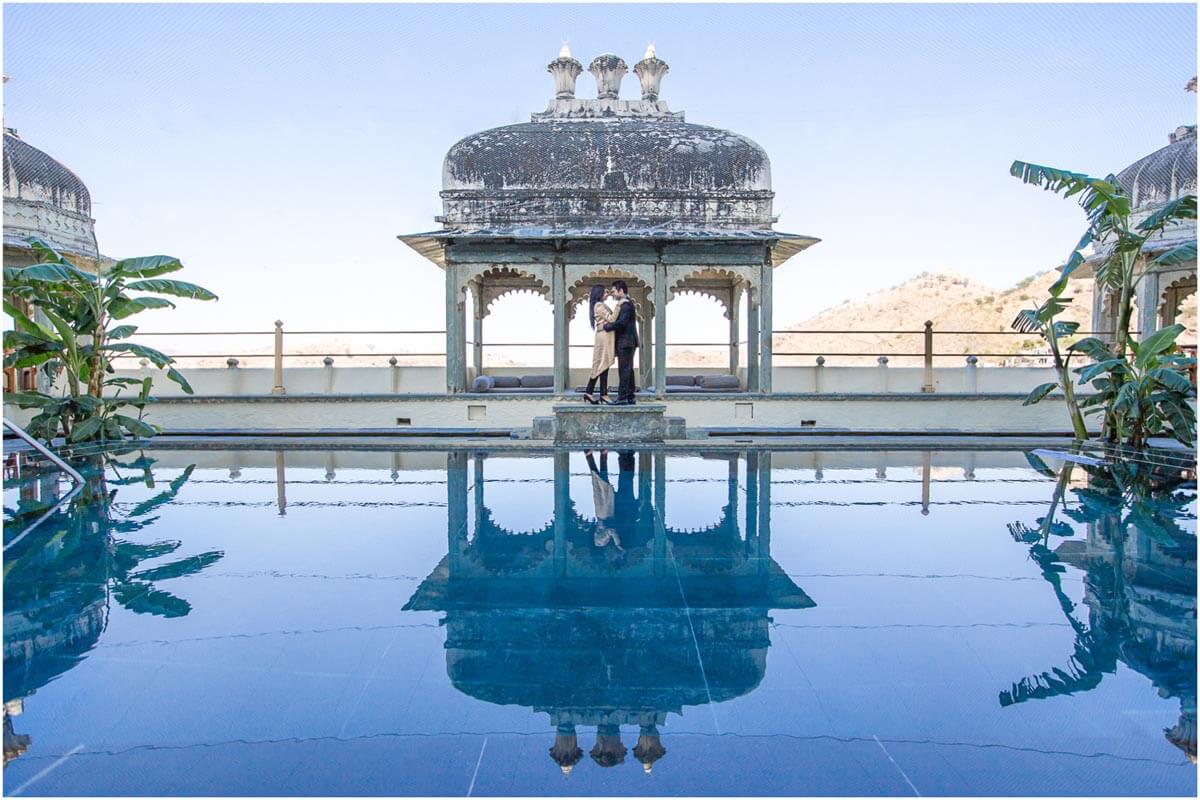 A couple with part of the RAAS Devigarh Palace in the background